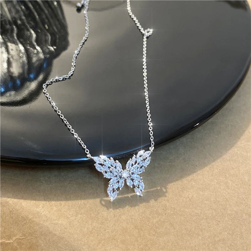 a silver necklace with a butterfly on it