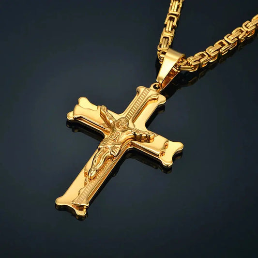 a gold cross necklace on a black background