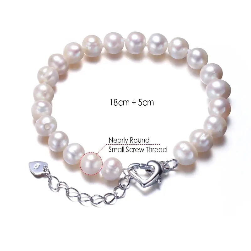 a white pearl bracelet with a heart charm
