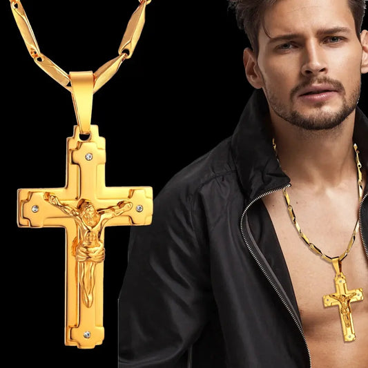 a man wearing a necklace and a cross necklace