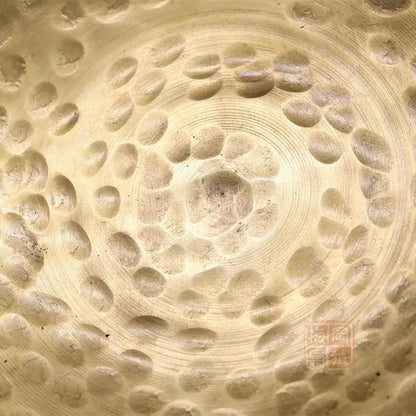 a close up of a bowl with holes in it