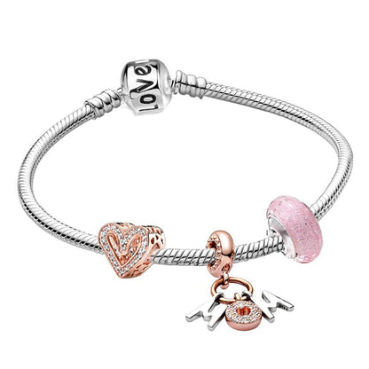 a pink charm bracelet with two charms on it