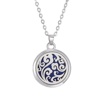 Stylish presentation of the Tree of Life Aromatherapy Necklace's stainless steel locket as an essential oil diffuser - stainless steel aroma necklace