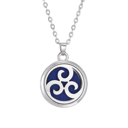A beautiful Tree of Life stainless steel aroma necklace displayed with essential oil pads for aromatic use - stainless steel aroma necklace