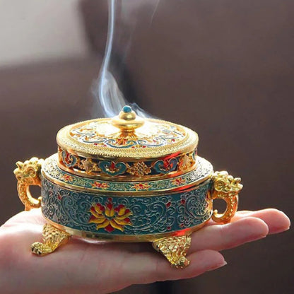 a hand holding a small metal box with smoke coming out of it