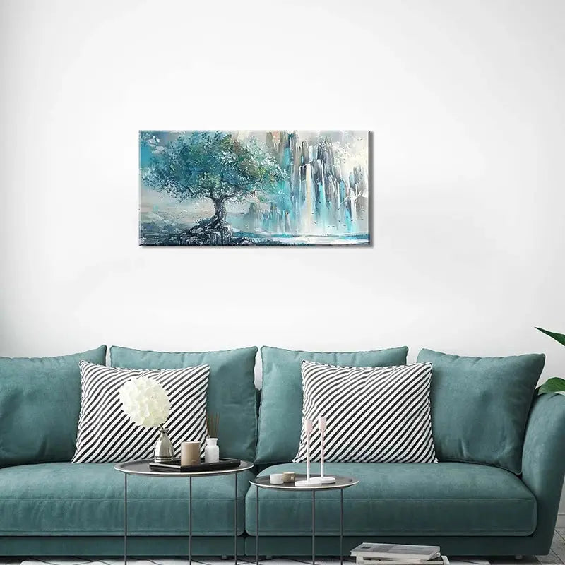 Charming turquoise mountain wall art displayed above a stylish couch, enhancing interior aesthetics.