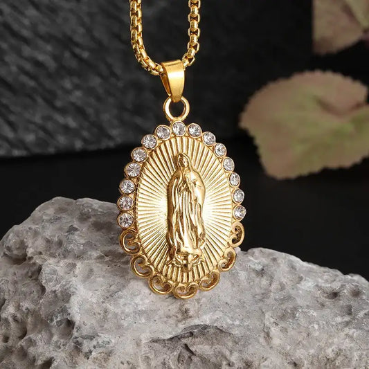 a gold pendant with a virgin mary on it