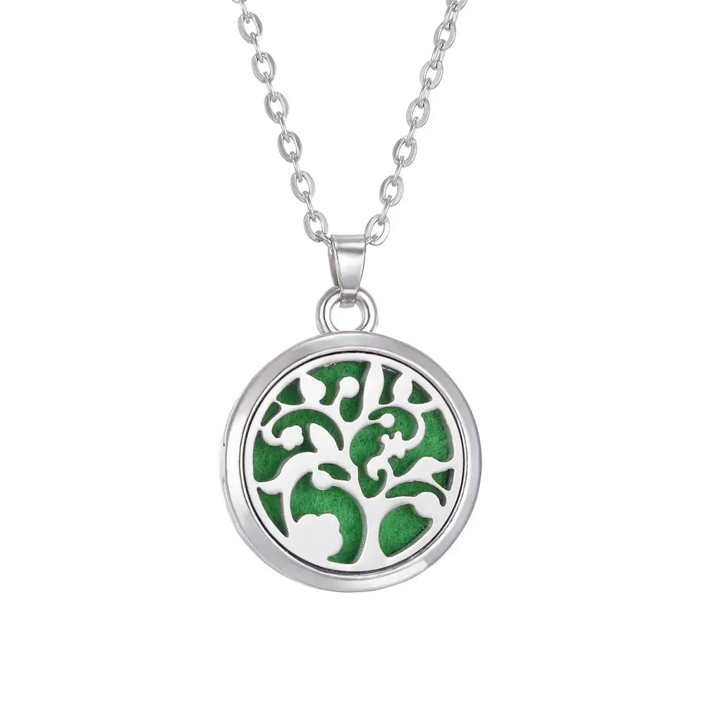 Essential oil pads being placed in the Tree of Life stainless steel aroma necklace for aromatic experience - stainless steel aroma necklace